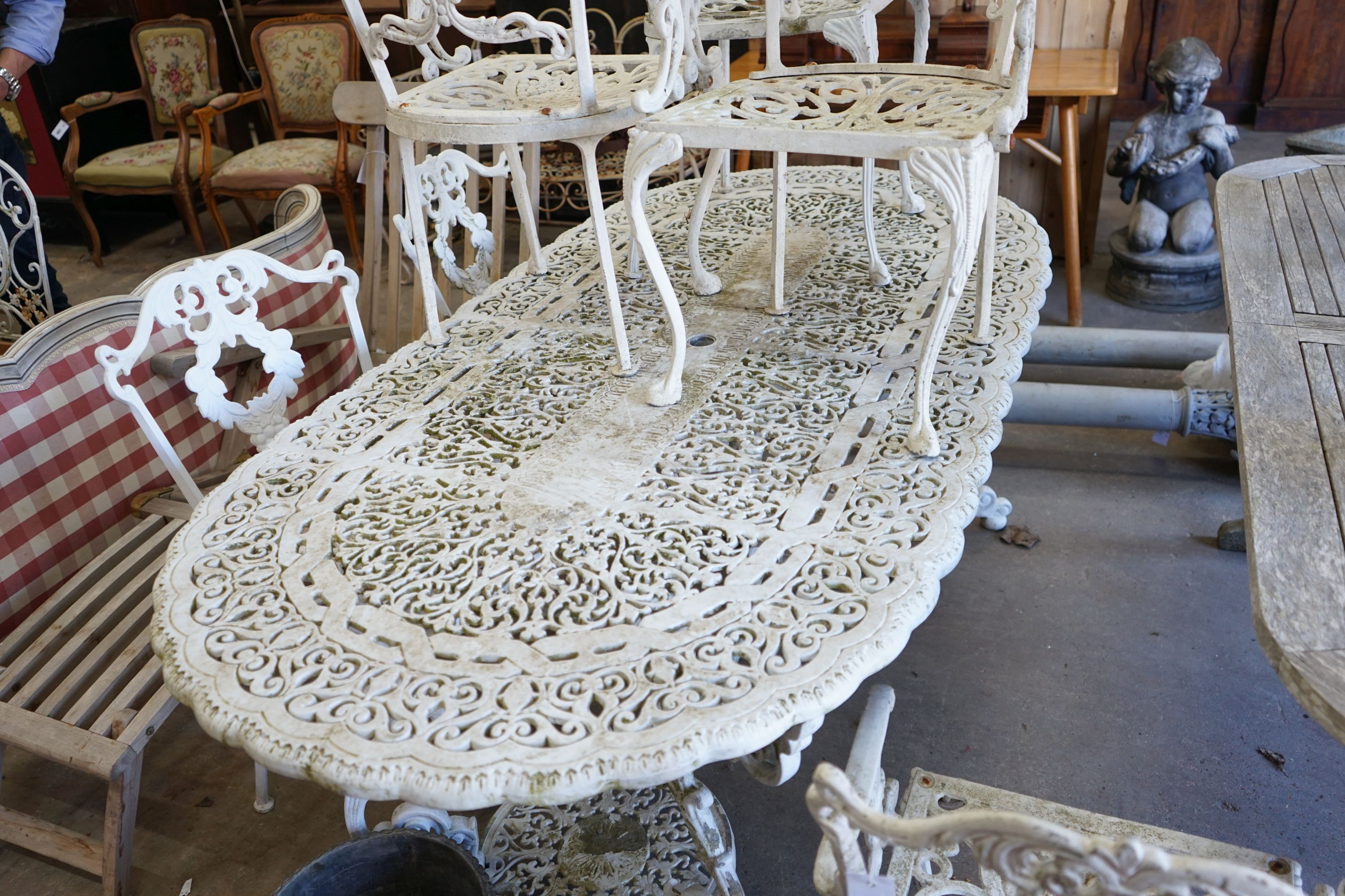 A Victorian style painted aluminium garden table, length 186cm, depth 94cm, height 72cm and six chairs in two sizes, two with arms